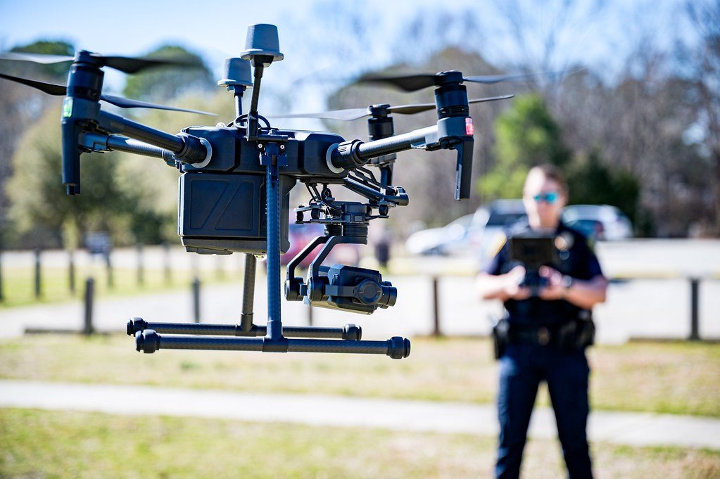 Public-safety drone hovering with its pilot behind